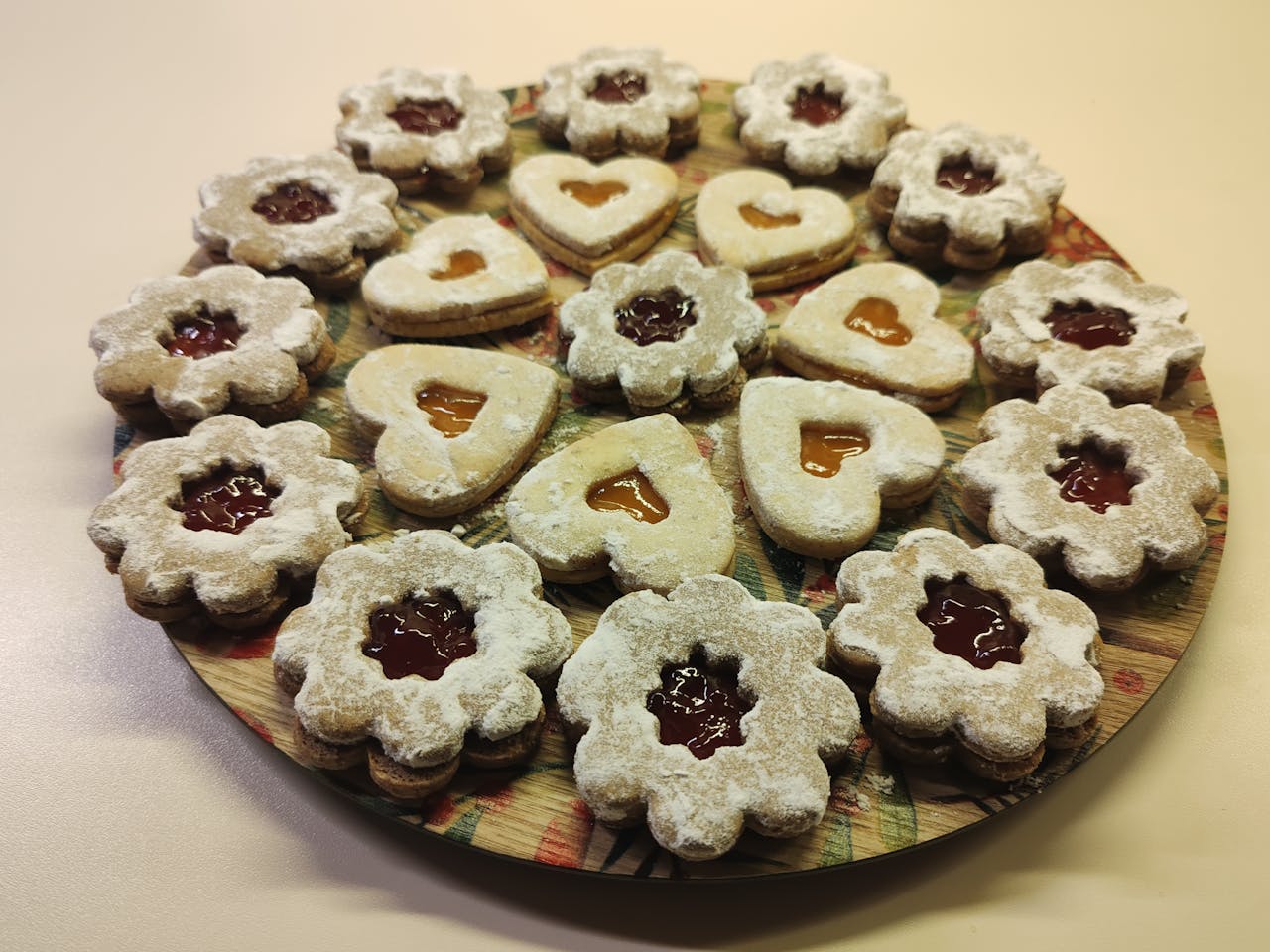 creative-03 A tempting platter of homemade jam-filled Linzer cookies, perfect for festive gatherings.